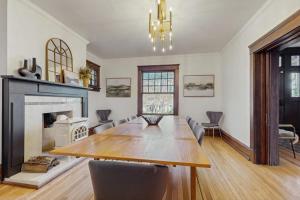 a dining room with a table and a fireplace at Love Lane Tudor in Waynesville