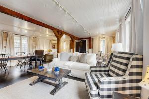a living room with a white couch and a table at Sassafras Cottage in Waynesville