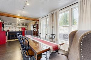 a kitchen and dining room with a table and chairs at Sassafras Cottage in Waynesville