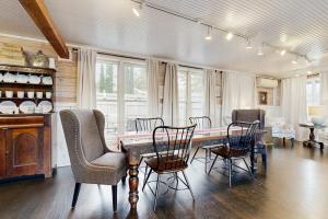 a dining room with a wooden table and chairs at Sassafras Cottage in Waynesville +20 photos