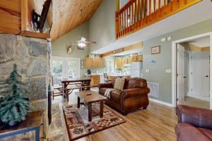 a living room with a couch and a table at Smoky View Retreat in Maggie Valley