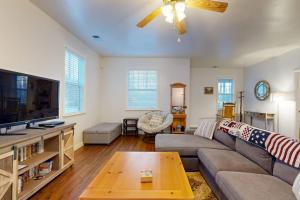 a living room with a couch and a flat screen tv at Mountain Hideaway in Sylva
