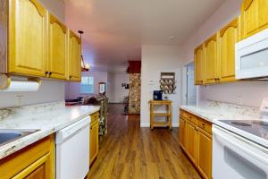 a kitchen with yellow cabinets and wooden floors at Mountain Hideaway in Sylva