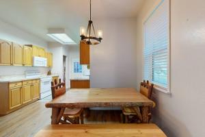 a kitchen with a wooden table and a dining room at Mountain Hideaway in Sylva +18 photos