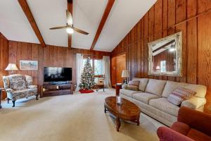 a living room with a couch and a christmas tree at Riverhill Ridge in Sylva