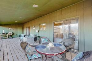 a room with a table and chairs on a deck at Riverhill Ridge in Sylva