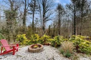 a red bench and a fire pit in a garden at Circular Mountain Retreat in Brevard