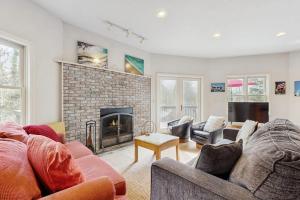 a living room with two couches and a fireplace at Circular Mountain Retreat in Brevard