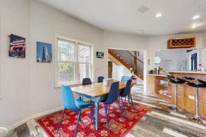 a dining room with a wooden table and blue chairs at Circular Mountain Retreat in Brevard