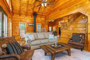 a living room with a couch and a table at The Lovely Cabin in Black Mountain