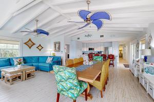a living room with a blue couch and a table at MA05 Bayfront Sunset Oasis in Marathon