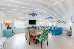 a living room with a table and a blue couch at MA05 Bayfront Sunset Oasis in Marathon