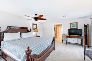 a bedroom with a bed and a flat screen tv at MA05 Bayfront Sunset Oasis in Marathon +45 photos