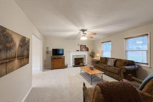 a living room with a couch and a fireplace at Come Together Place in Candler +26 photos
