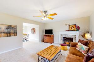 a living room with a couch and a fireplace at Come Together Place in Candler