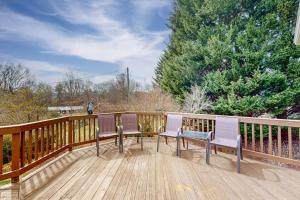 a deck with three chairs and a bench on it at Come Together Place in Candler