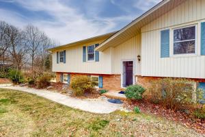 a brick house with a red door and a driveway at Come Together Place in Candler