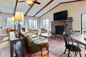a living room with a couch and a fireplace at The Nunv Cabin in Brevard