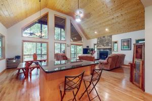 a kitchen and living room with a table and chairs at Talking River Chalet in Murphy +17 photos