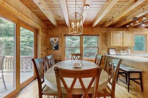 a dining room with a table and chairs in a cabin at Bird's Nest in Saluda