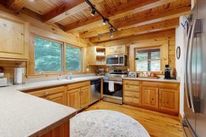 a large kitchen with wooden walls and wooden floors at Bird's Nest in Saluda