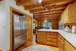 a kitchen with a stainless steel refrigerator and wooden cabinets at Bird's Nest in Saluda +12 photos