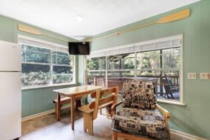 eine Küche mit Tisch, Stuhl und Kühlschrank in der Unterkunft River Romance in Sylva