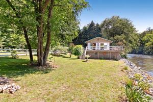 a small house on the banks of a river at 2 Bed 1 Bath Vacation home in Sylva in Sylva