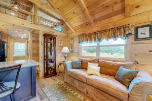 a living room with a couch in a log cabin at Deimos Cabin in Mars Hill