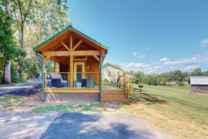 a gazebo with chairs in a yard at Deimos Cabin in Mars Hill