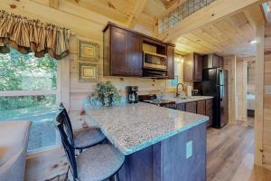 a kitchen with a large island in a cabin at Deimos Cabin in Mars Hill +20 photos