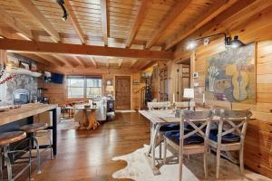 a kitchen and dining room with a table and chairs at Bear Hug in Sylva