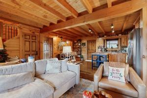 a living room with a couch and a kitchen at Bear Hug in Sylva