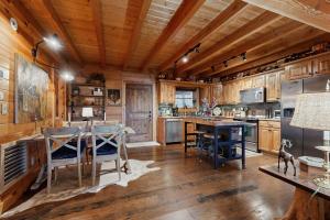 a kitchen with a wooden ceiling and a table and chairs at Bear Hug in Sylva