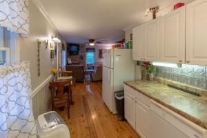 a kitchen with white cabinets and a white refrigerator at The Reed House in Dillsboro +33 photos