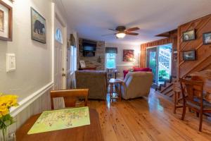 a living room with a table and a dining room at The Reed House in Dillsboro