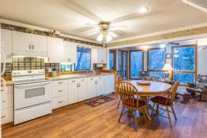 a kitchen with a table and a dining room at Creekside Lodge in Franklin