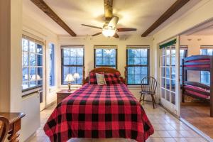 a bedroom with a bed with a checkered blanket at Creekside Lodge in Franklin +10 photos