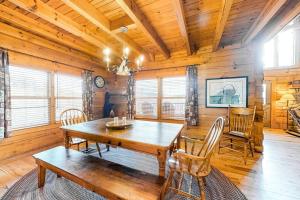 a dining room with a wooden table and chairs at Timberidge Lodge in Sylva
