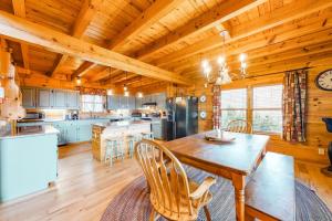 a kitchen with a table and chairs in a cabin at Timberidge Lodge in Sylva