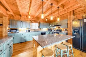 a large kitchen with blue cabinets and a large island at Timberidge Lodge in Sylva
