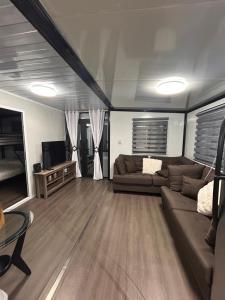 a living room with a couch and a television at Babus Villas del Sol in El Combate