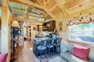 a kitchen and living room in a tiny house at Phobos Cabin in Mars Hill
