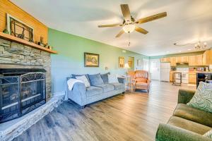 a living room with a couch and a fireplace at Chipmunk Lane in Maggie Valley