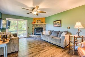 a living room with a couch and a fireplace at Chipmunk Lane in Maggie Valley