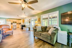 a living room with a couch and a ceiling fan at Chipmunk Lane in Maggie Valley