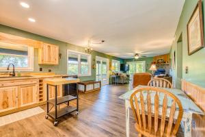 a kitchen with green walls and a table and chairs at Chipmunk Lane in Maggie Valley +20 photos