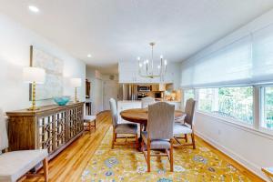 a kitchen and dining room with a table and chairs at Blue Ridge Cottage in Waynesville