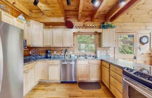 a kitchen with wooden cabinets and a counter top at 4 Bed 4 Bath Vacation home in Sylva in Sylva