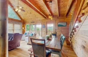 a dining room and living room with a wooden ceiling at 4 Bed 4 Bath Vacation home in Sylva in Sylva